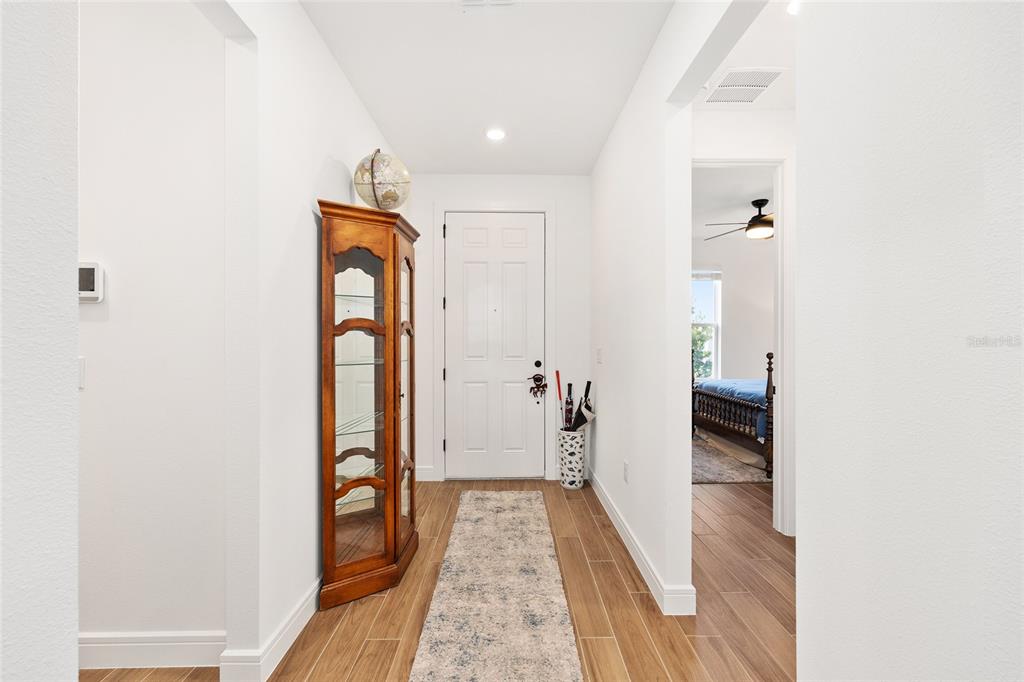8989 Southwest 57th Pl Road Ocala, FL 34481 - Photo 5 of 47 a view of a hallway with wooden floor and staircase