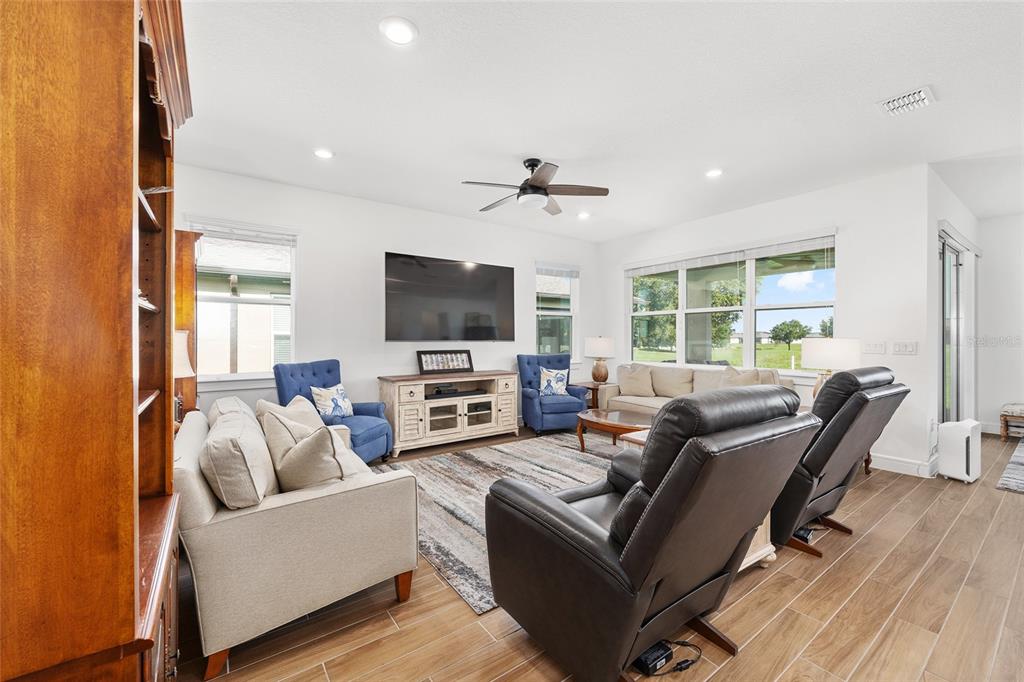 8989 Southwest 57th Pl Road Ocala, FL 34481 - Photo 6 of 47 a living room with furniture and a flat screen tv