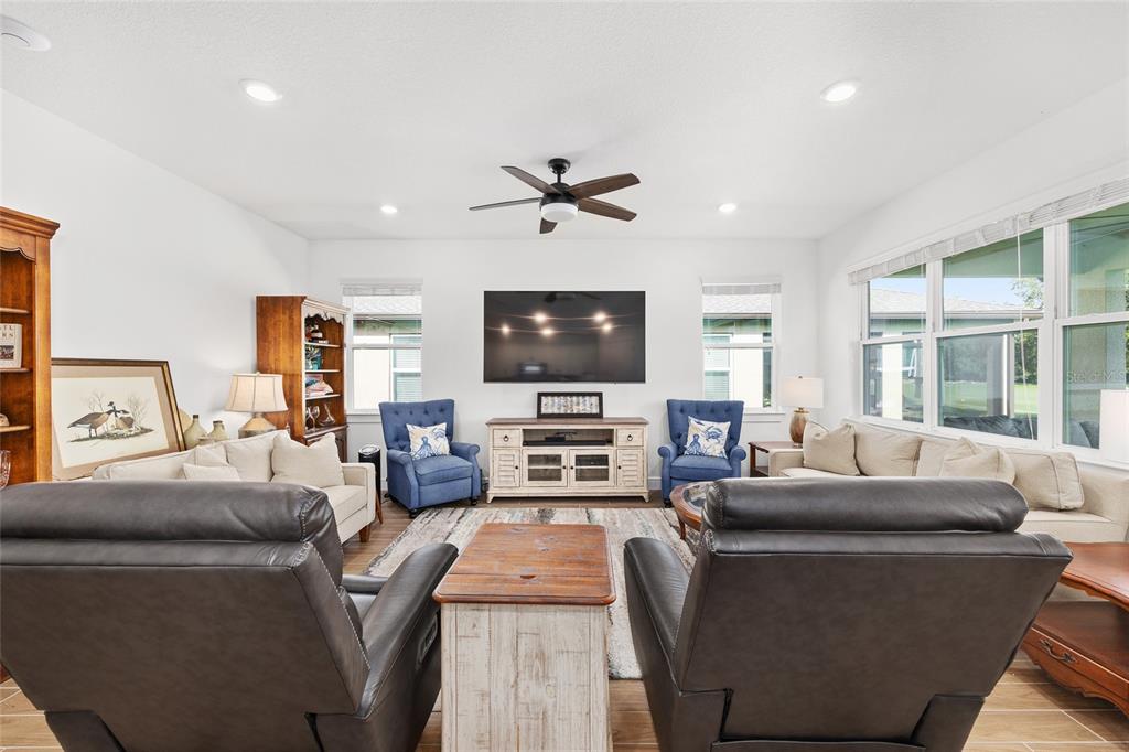 8989 Southwest 57th Pl Road Ocala, FL 34481 - Photo 9 of 47 a living room with furniture and a flat screen tv
