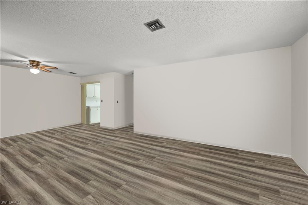 116 Harrison Road, Unit N3 Naples, FL 34112 - Photo 8 of 24 Living and dining areas with furnishing removed virtually