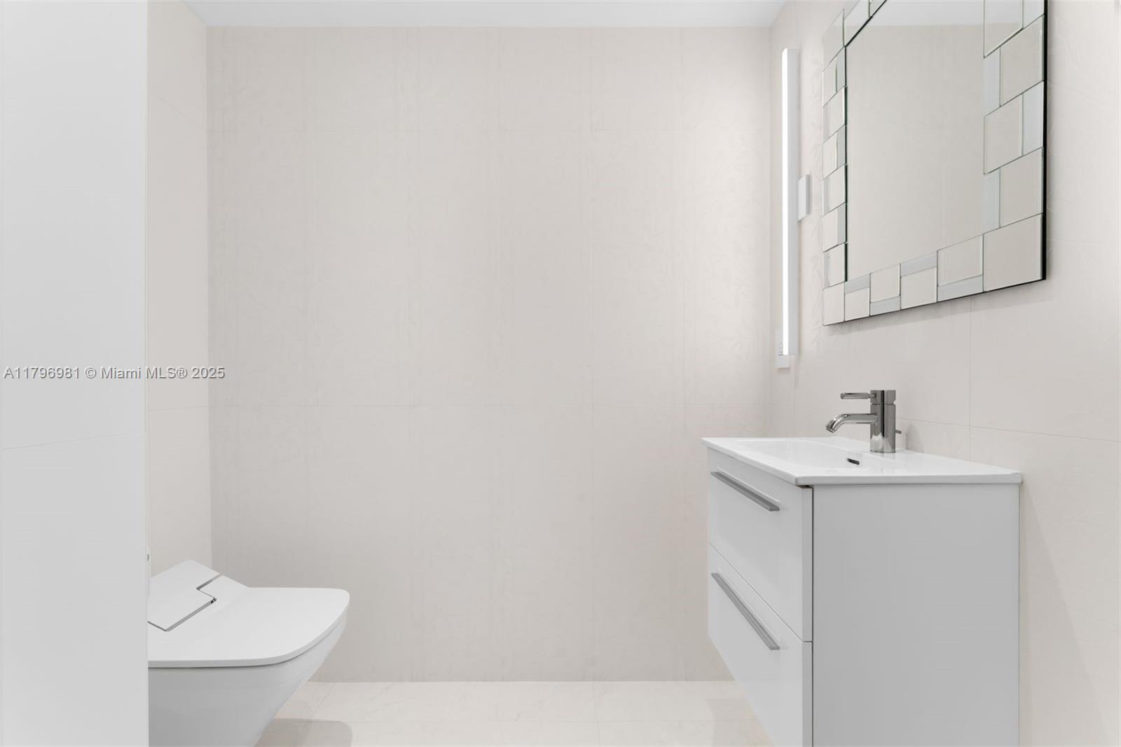 9801 Collins Avenue, Unit 17P Bal Harbour, FL 33154 - Photo 11 of 31 a bathroom with a sink a toilet and mirror