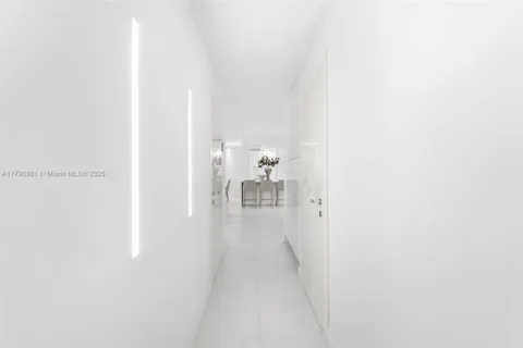 a view of a hallway with two couches and a coffee table