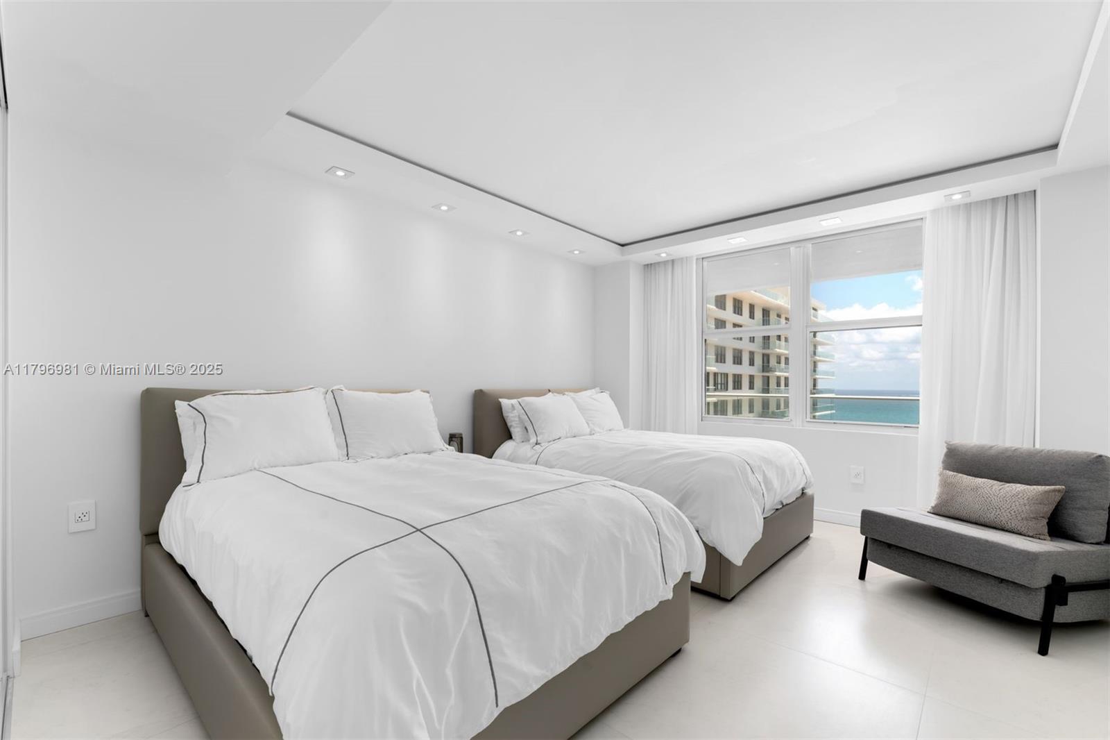 9801 Collins Avenue, Unit 17P Bal Harbour, FL 33154 - Photo 13 of 31 a bedroom with two beds and a couch