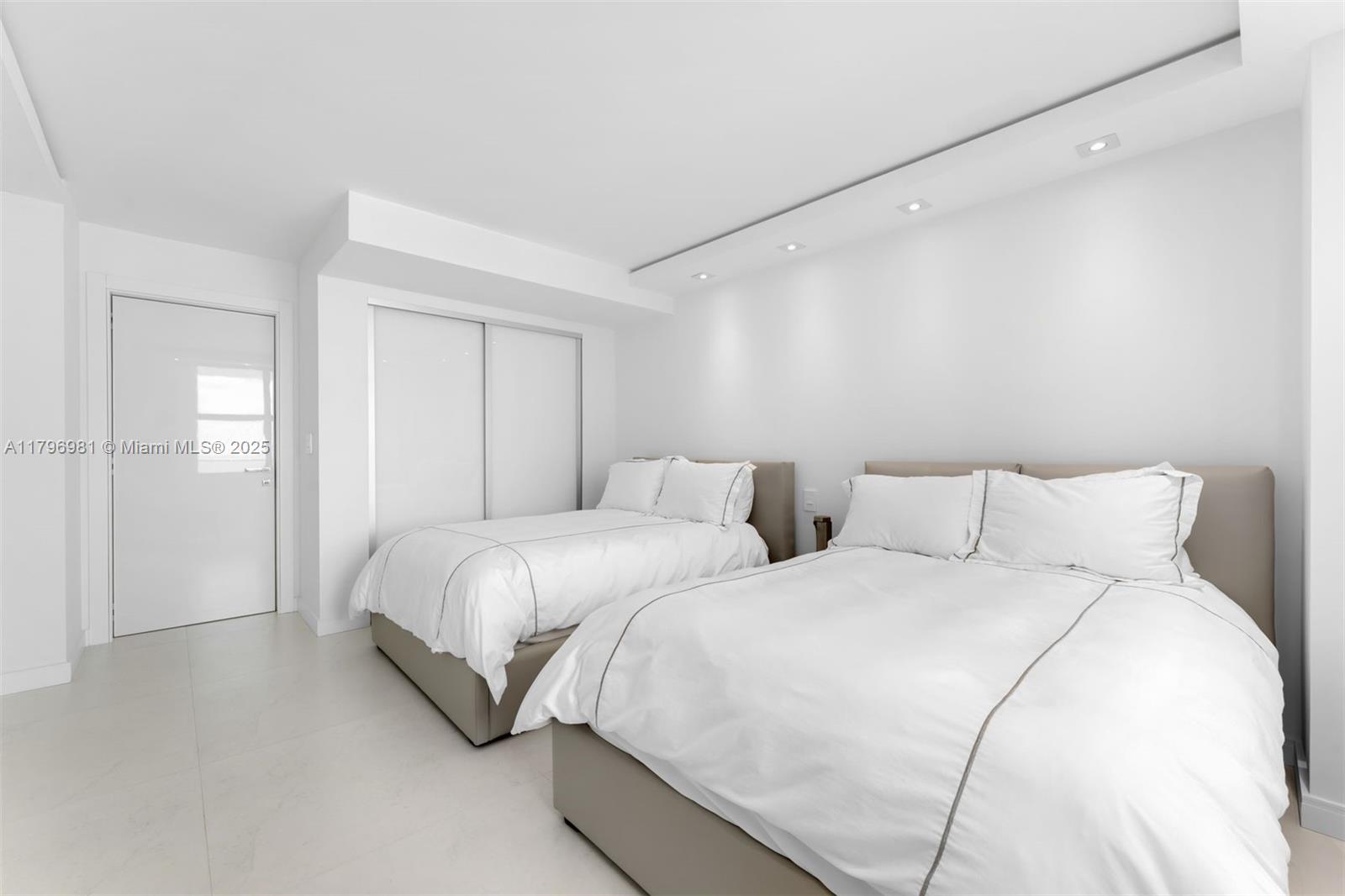 9801 Collins Avenue, Unit 17P Bal Harbour, FL 33154 - Photo 14 of 31 a large white bed in a white room