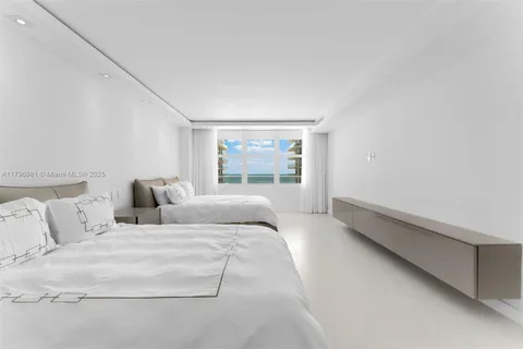 a large white bed in a white room