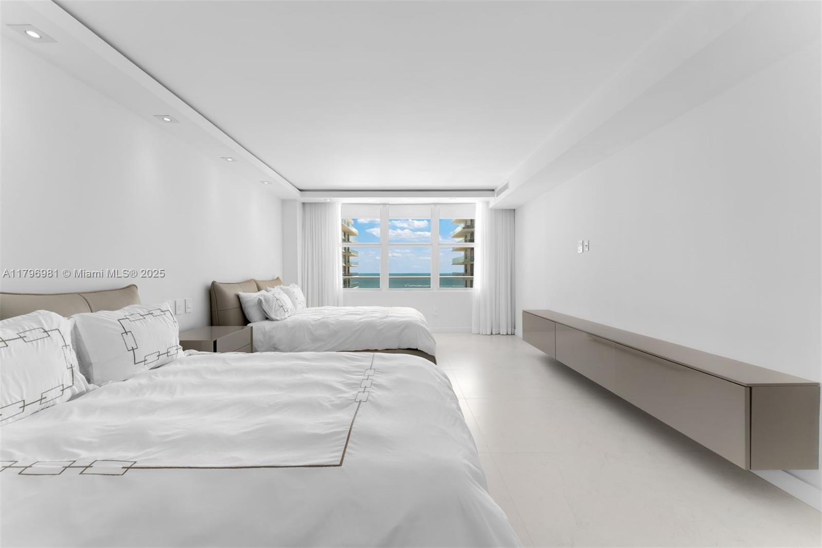 9801 Collins Avenue, Unit 17P Bal Harbour, FL 33154 - Photo 16 of 31 a large white bed in a white room