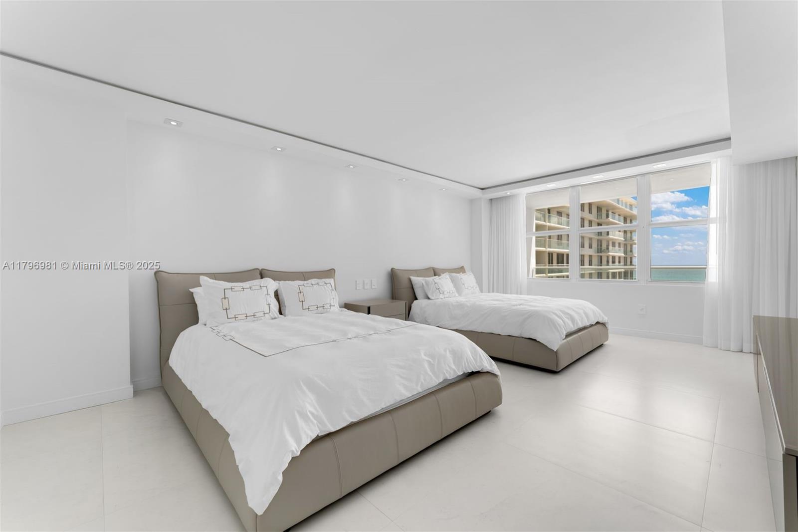 9801 Collins Avenue, Unit 17P Bal Harbour, FL 33154 - Photo 18 of 31 a bedroom with bed and a large window