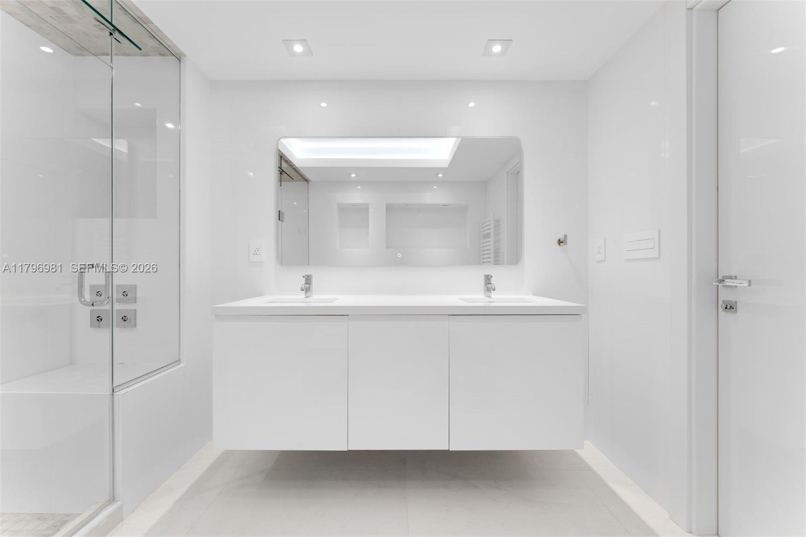 9801 Collins Avenue, Unit 17P Bal Harbour, FL 33154 - Photo 22 of 31 a bathroom with a sink a shower and a mirror