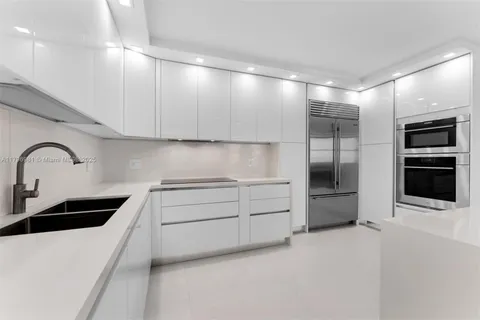 a kitchen with cabinets and stainless steel appliances