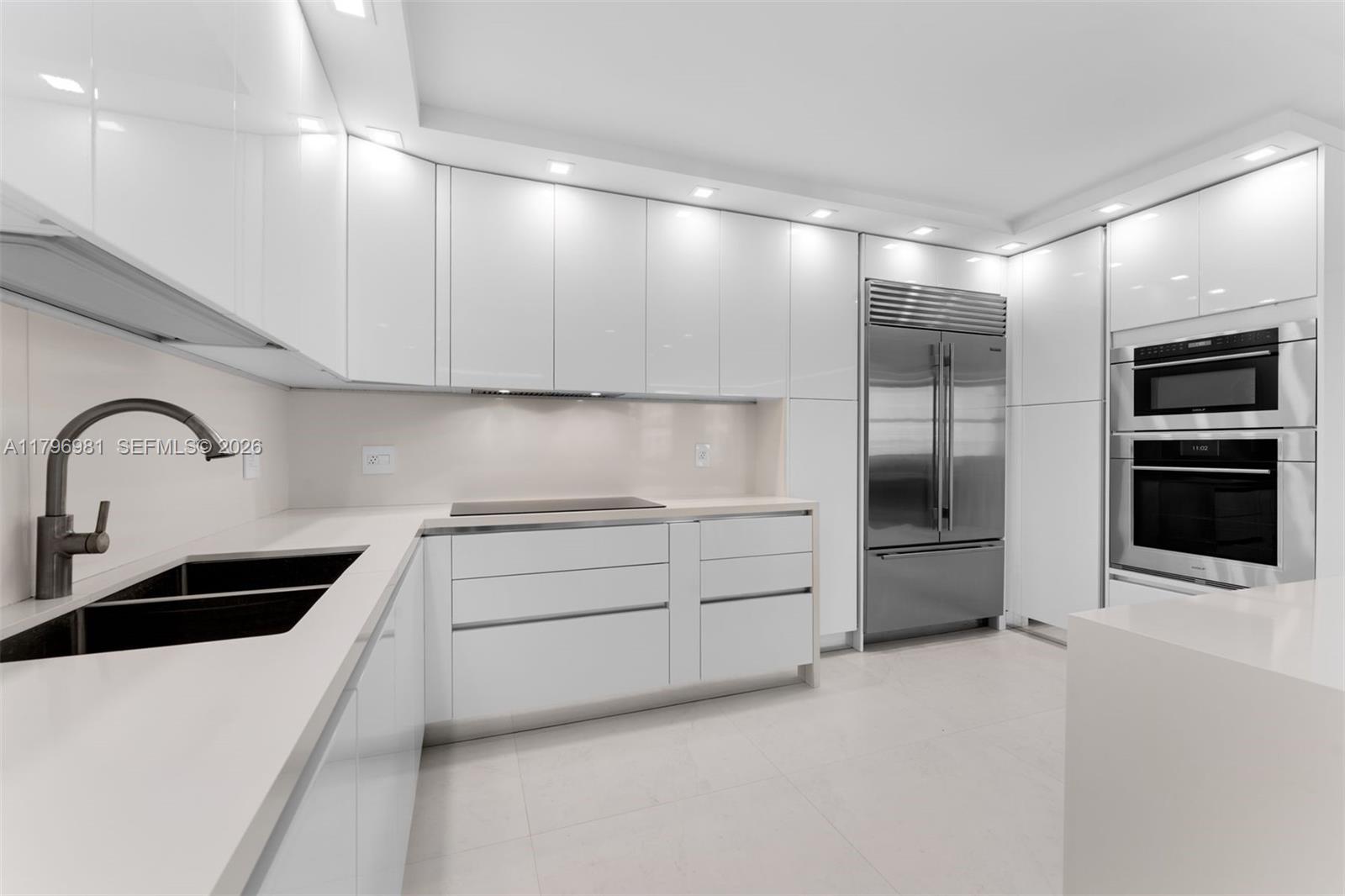 9801 Collins Avenue, Unit 17P Bal Harbour, FL 33154 - Photo 9 of 31 a kitchen with cabinets and stainless steel appliances