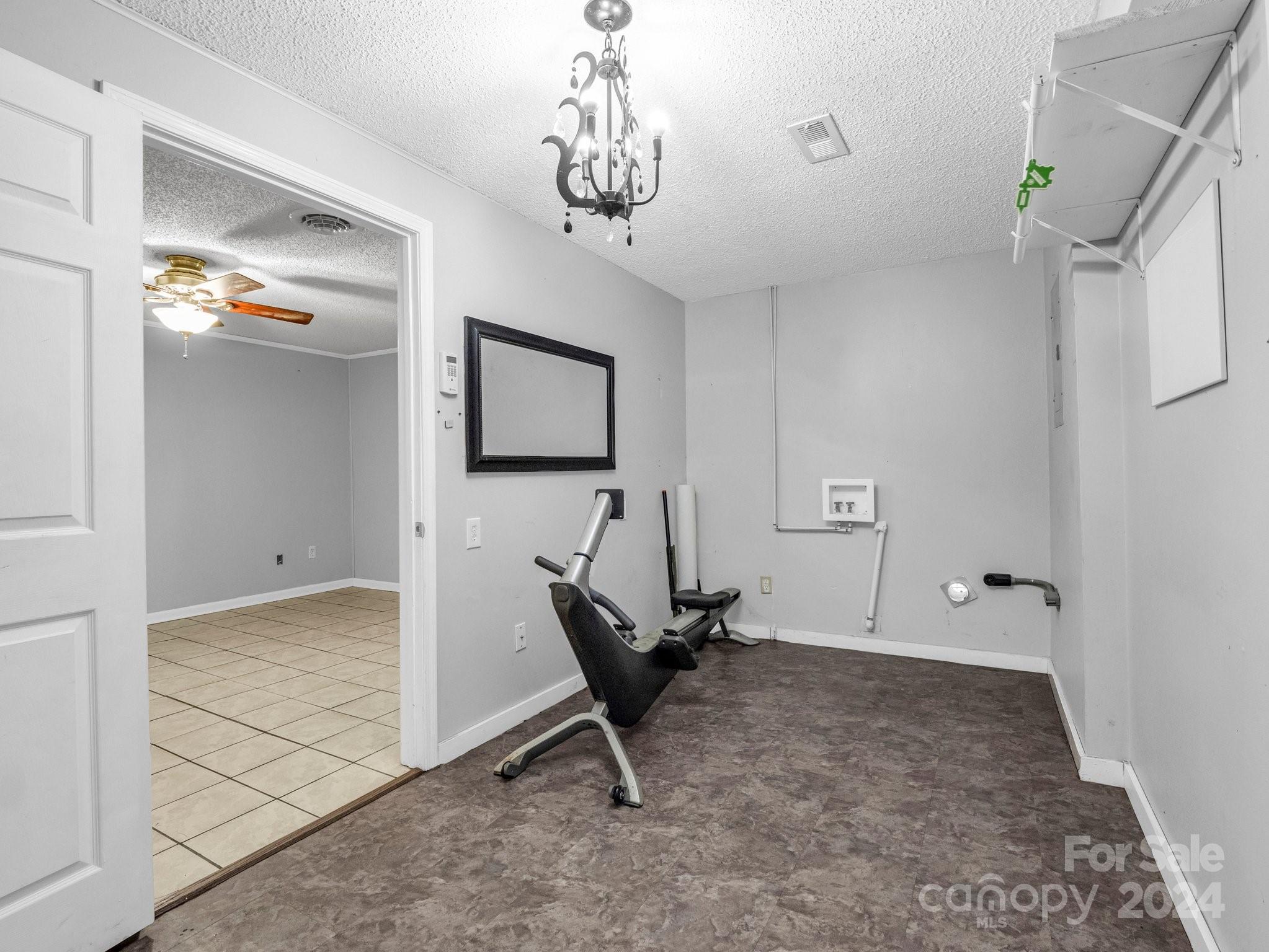 3401 Spencer Road Conover, NC 28613 - Photo 11 of 34 a living room with a couch and a chandelier