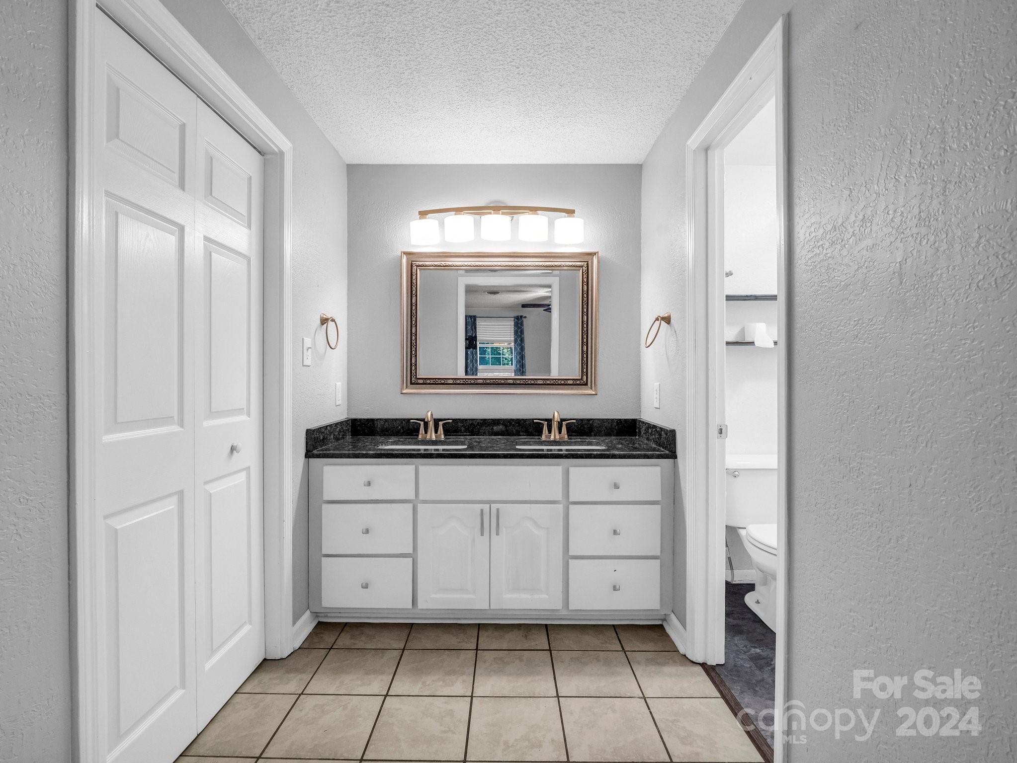 3401 Spencer Road Conover, NC 28613 - Photo 17 of 34 a bathroom with a granite countertop sink a mirror and a bathtub