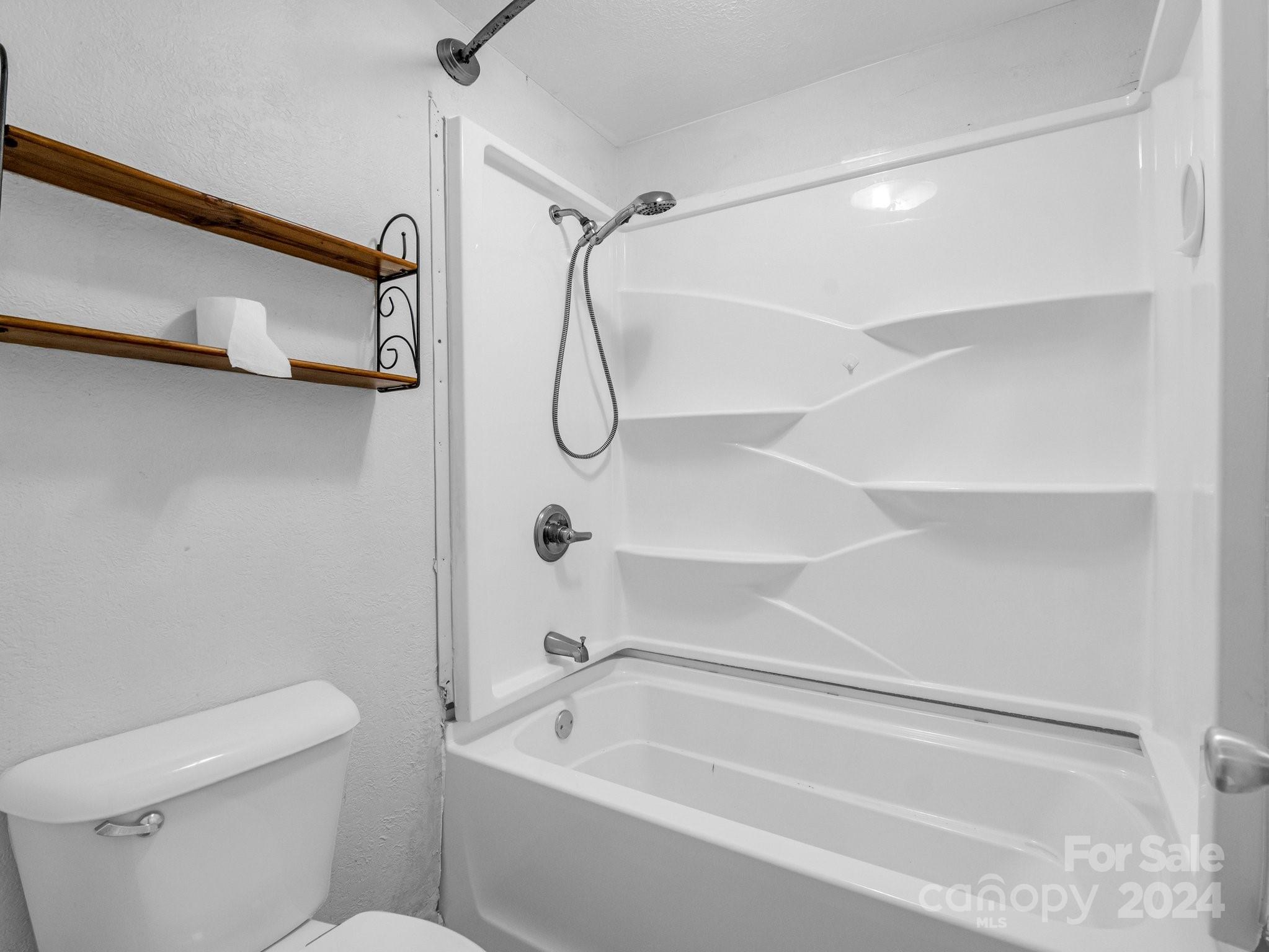 3401 Spencer Road Conover, NC 28613 - Photo 18 of 34 a bathroom with a shower a toilet and a shower