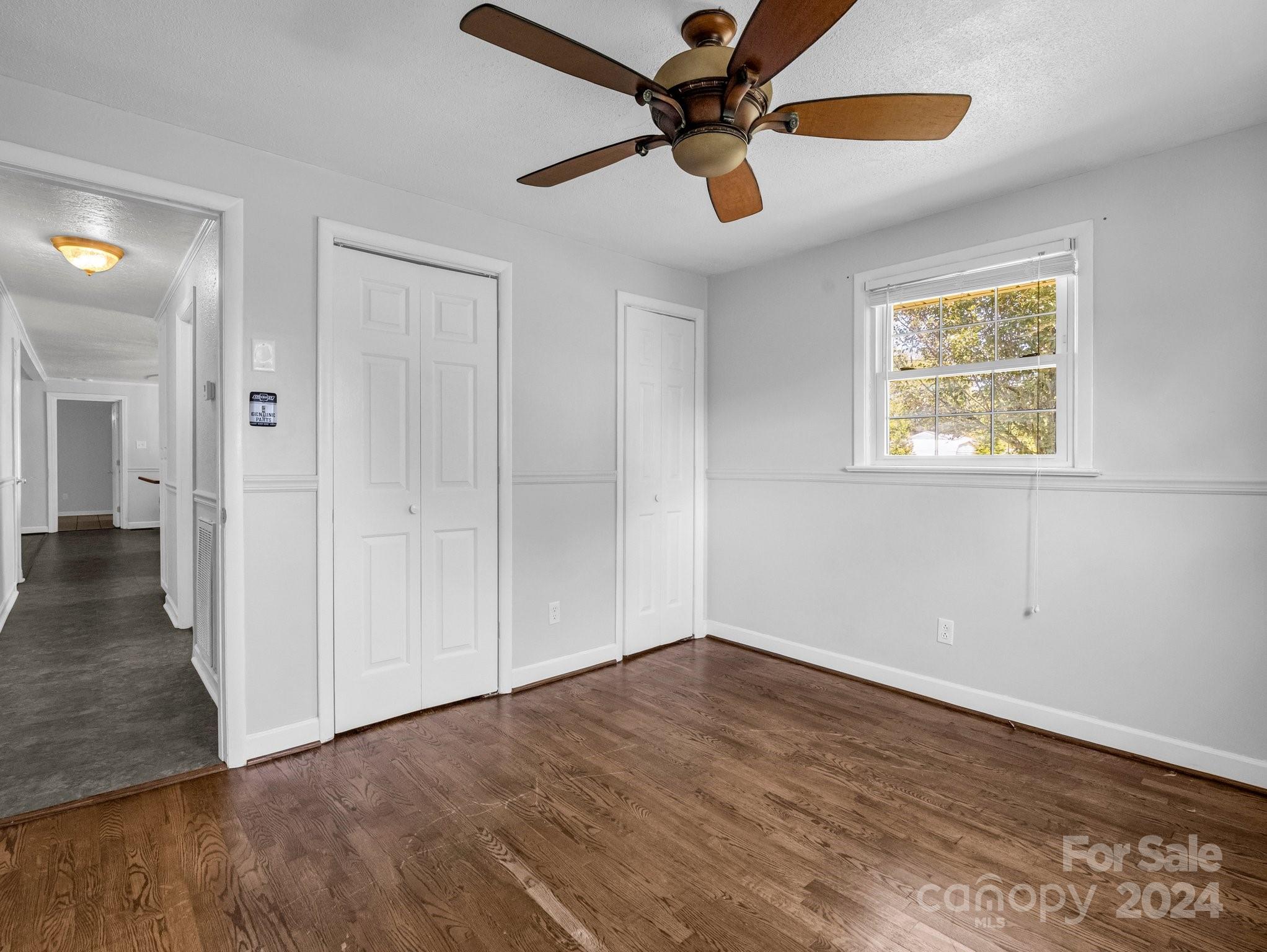 3401 Spencer Road Conover, NC 28613 - Photo 22 of 34 an empty room with wooden floor fan and windows
