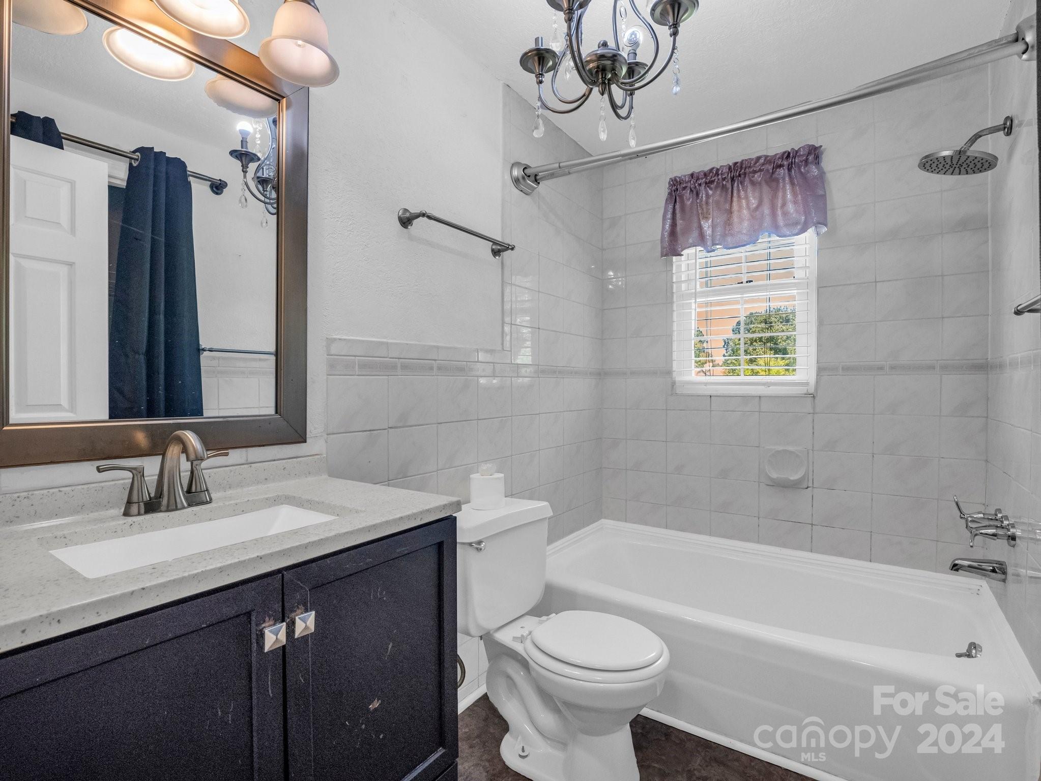 3401 Spencer Road Conover, NC 28613 - Photo 28 of 34 a bathroom with a sink a toilet a mirror a bathtub and shower