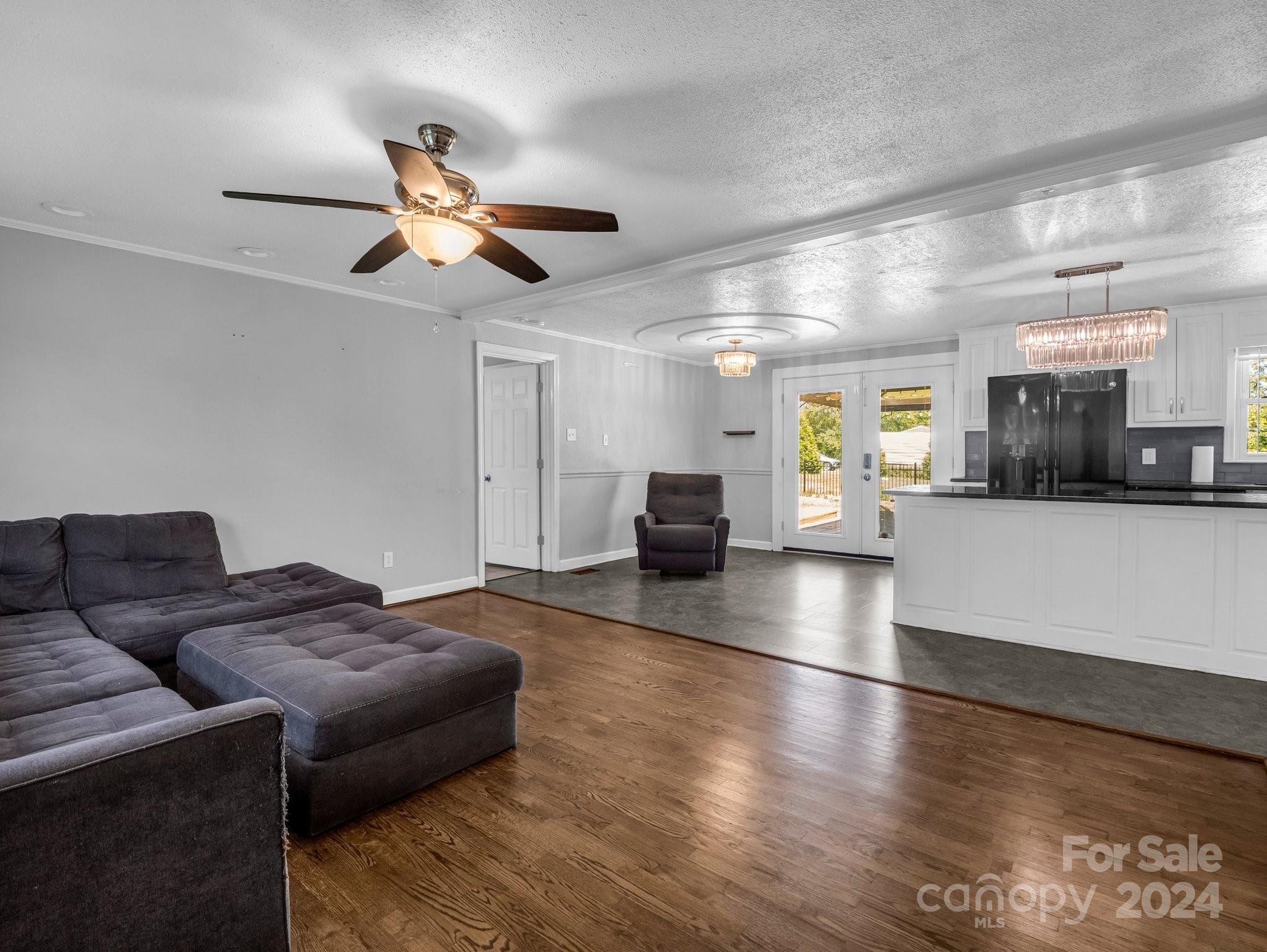 3401 Spencer Road Conover, NC 28613 - Photo 5 of 34 a living room with couches and kitchen view with wooden floor