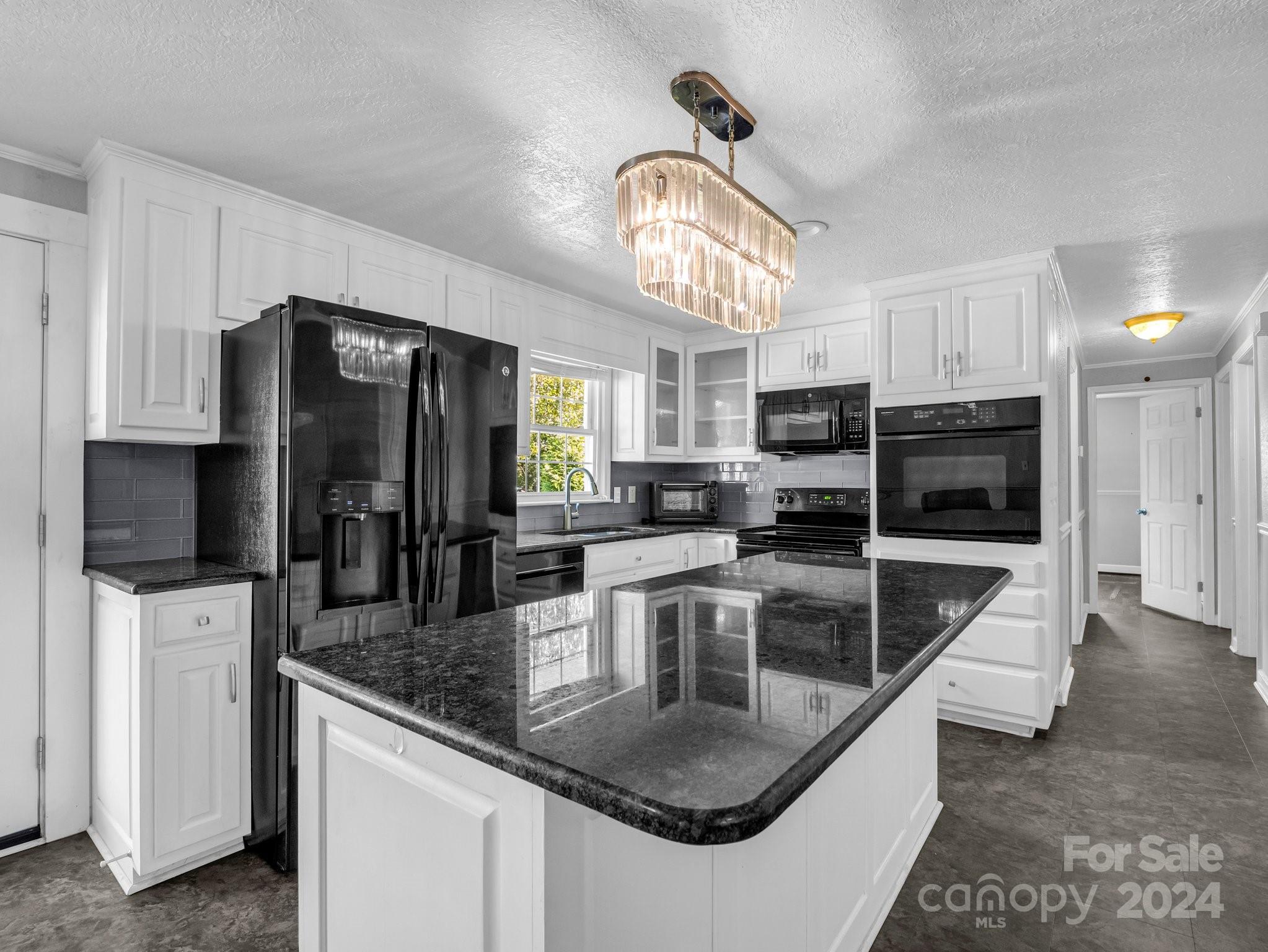 3401 Spencer Road Conover, NC 28613 - Photo 8 of 34 a kitchen with stainless steel appliances granite countertop a sink a stove and a refrigerator