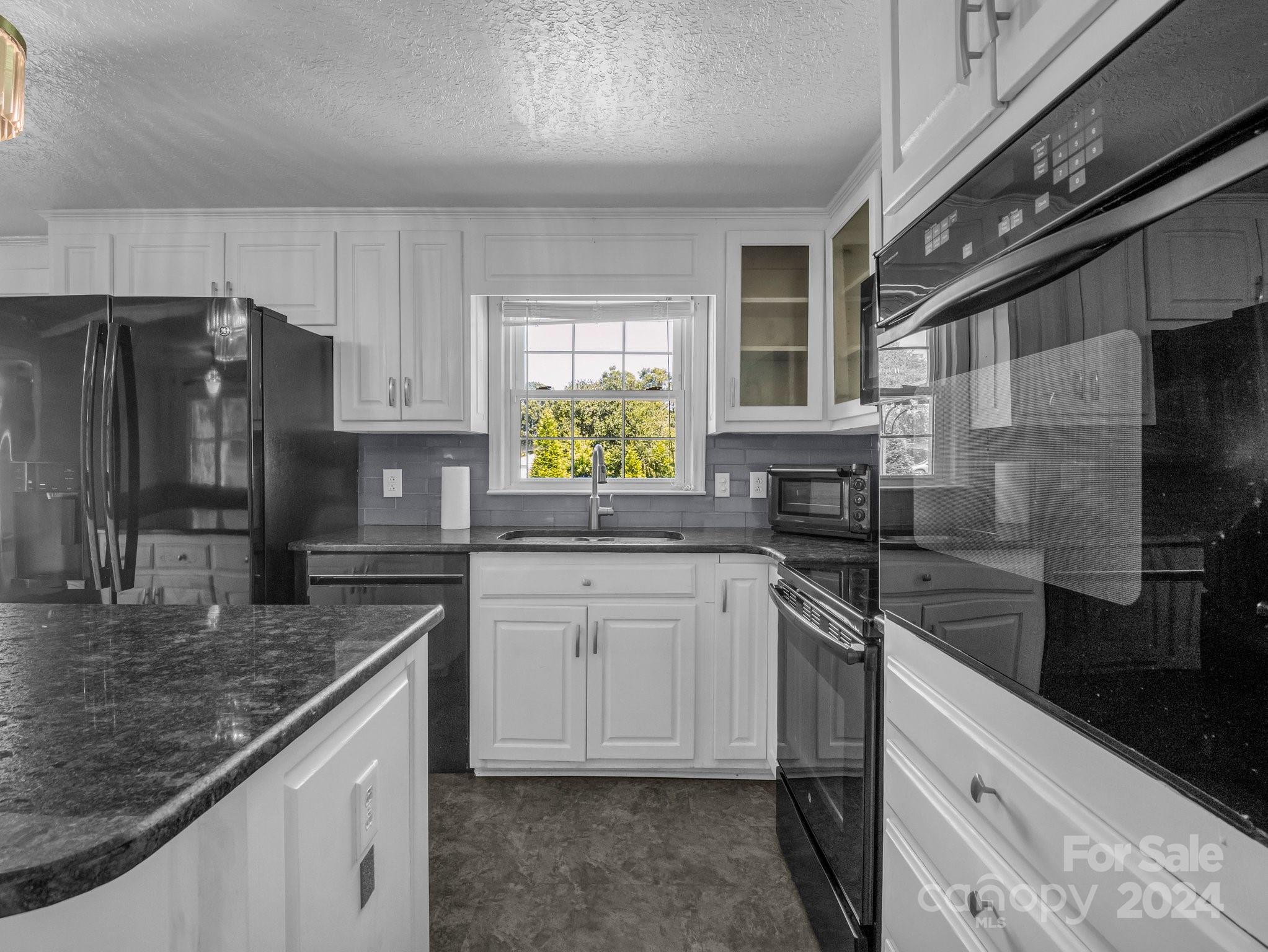 3401 Spencer Road Conover, NC 28613 - Photo 9 of 34 a kitchen with stainless steel appliances granite countertop a sink a stove and cabinets