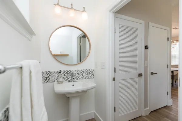 a bathroom with a sink a mirror and a toilet