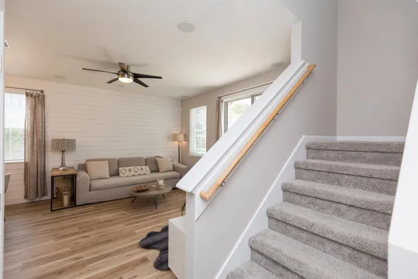 a living room with furniture and stairs