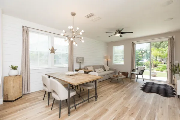 a view of a dining room with furniture window and wooden floor