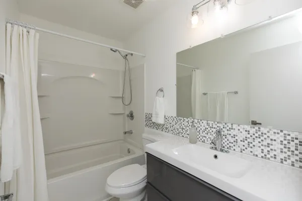 a bathroom with a sink toilet and mirror