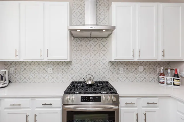 a stove top oven sitting inside of a kitchen