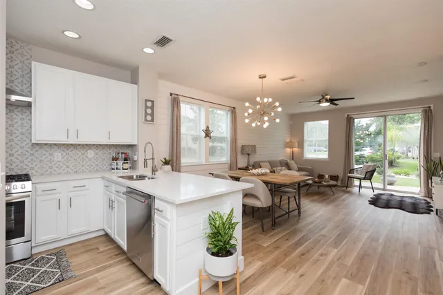 a open kitchen with sink cabinets and wooden floor