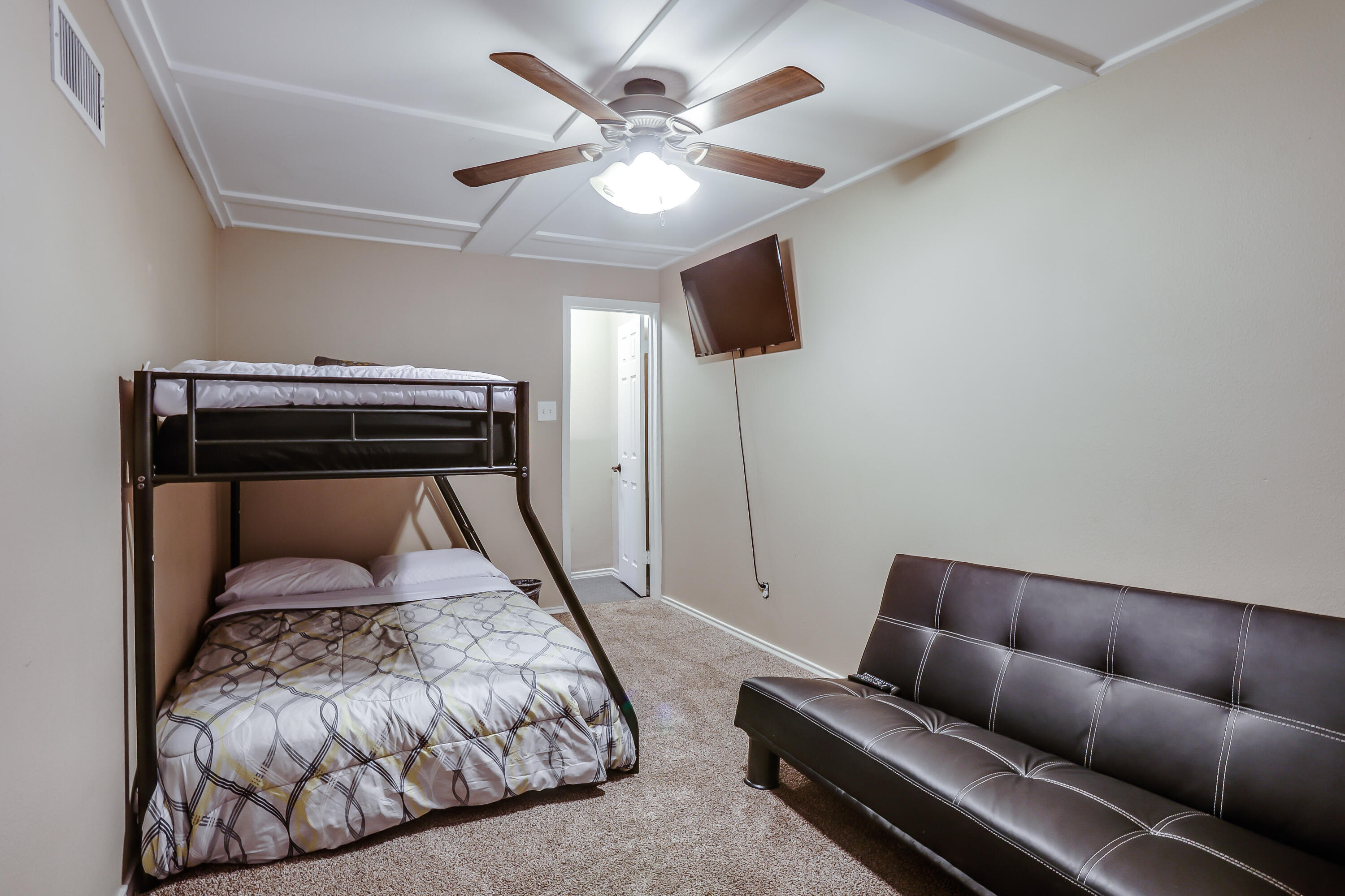68 Pony Express Trail Lubbock, TX 79404 - Photo 13 of 15 a bedroom with a bed and a chandelier
