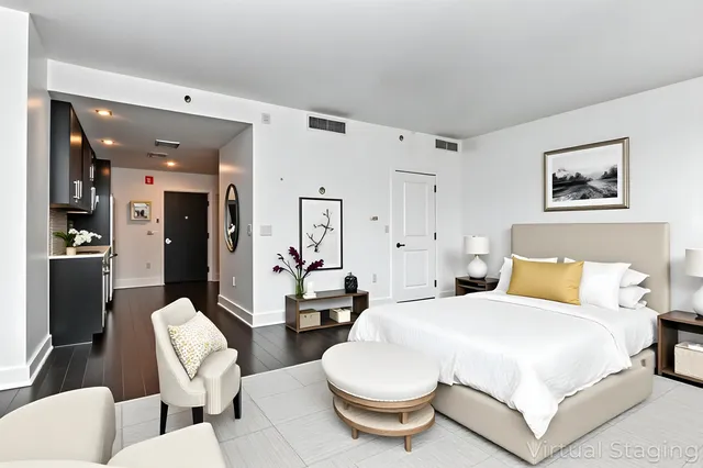 a bedroom with a bed and a chandelier