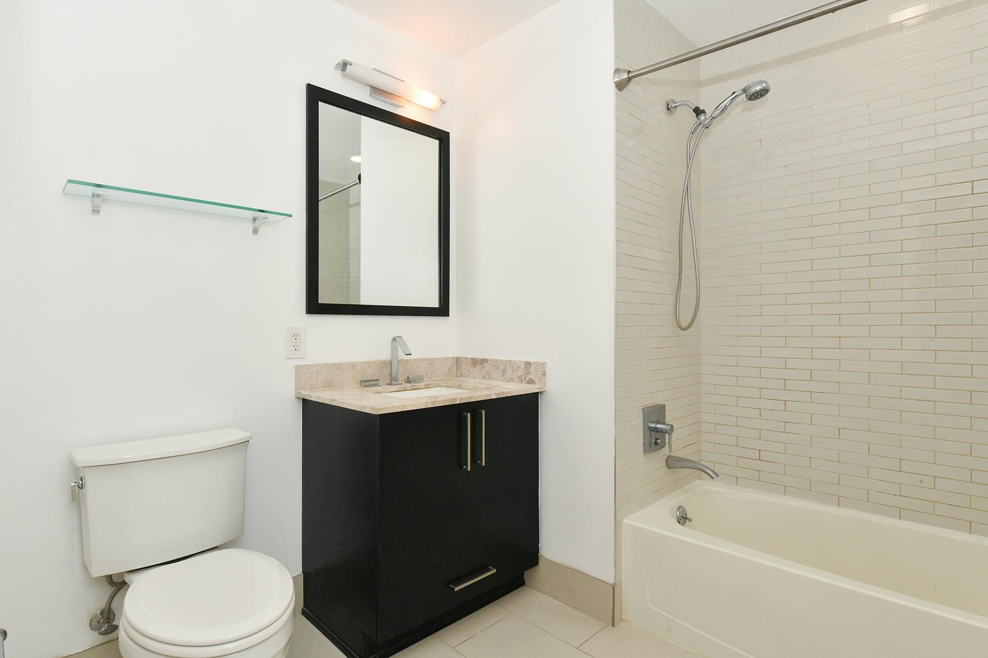1100 Maxwell Lane, Unit 517 Hoboken, NJ 07030 - Photo 11 of 17 a bathroom with a sink toilet and shower