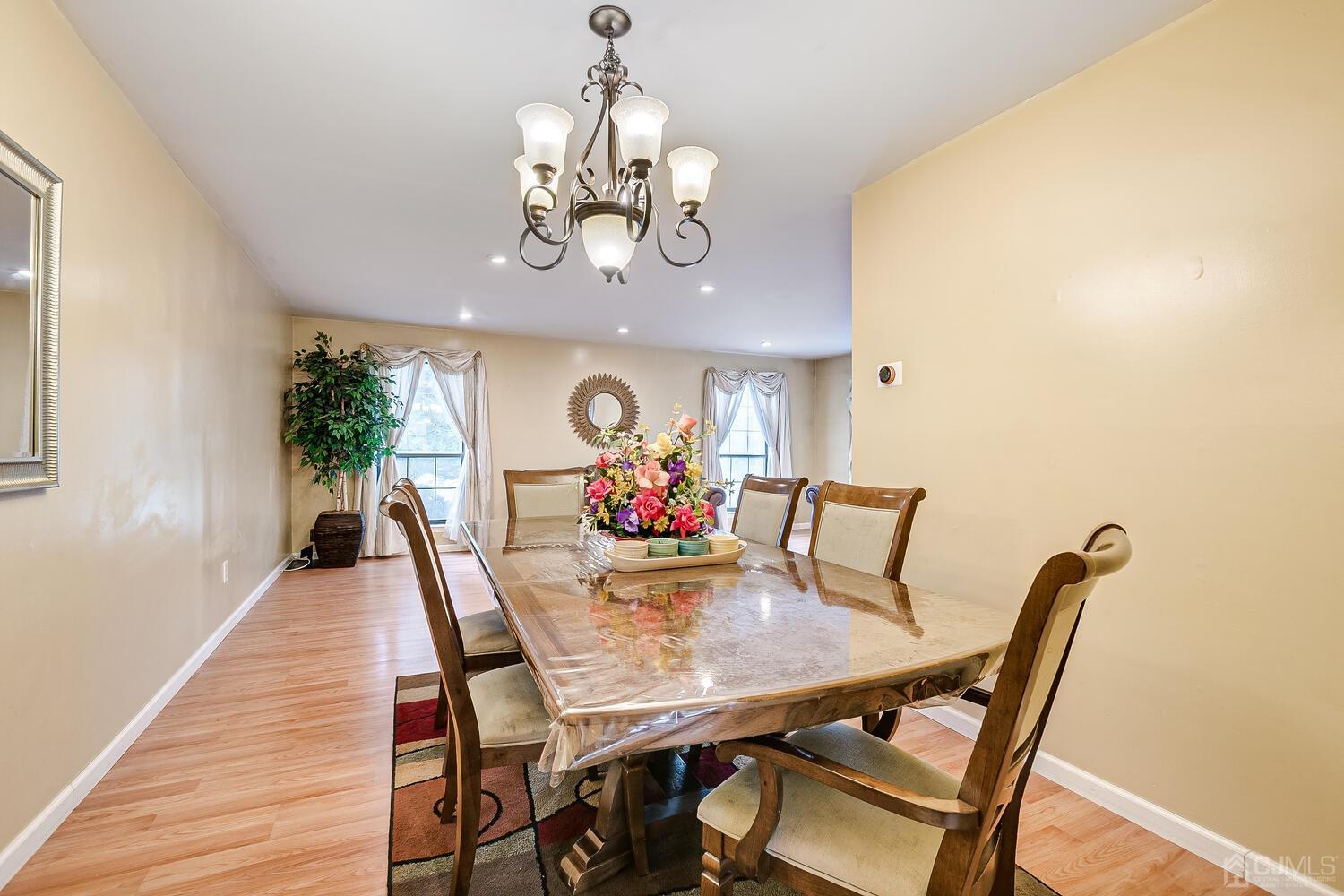 2701 Cricket Circle Edison, NJ 08820 - Photo 13 of 38 a view of a dining room with furniture a chandelier and wooden floor