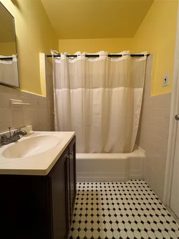 a bathroom with a sink a mirror and a shower