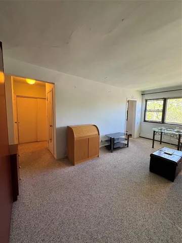 a bed room with furniture and window