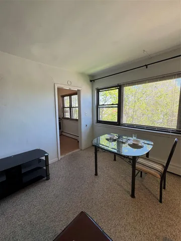 a room with furniture pool table and windows