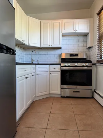a kitchen with cabinets and appliances