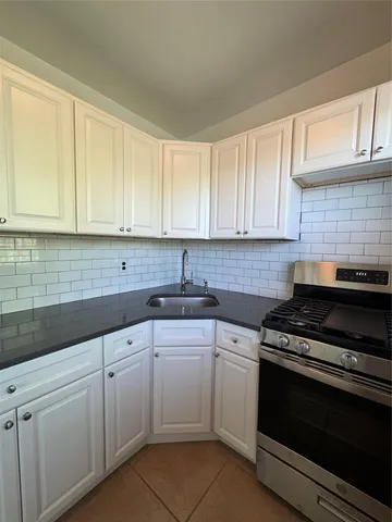 a kitchen with cabinets appliances and a sink