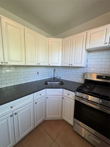 a kitchen with cabinets and a refrigerator