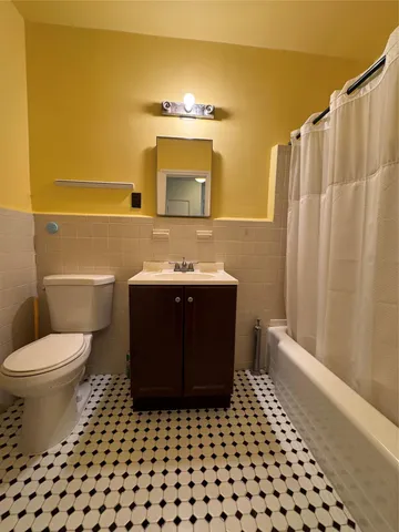 a bathroom with a sink a toilet a mirror and shower