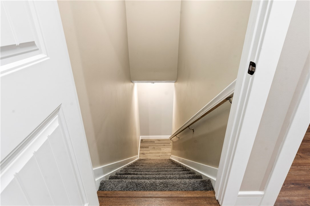 1158 Pyle Road Clarksville, OH 45113 - Photo 40 of 76 This interior staircase features carpet and a sturdy handrail leading to the expansive finished basement.