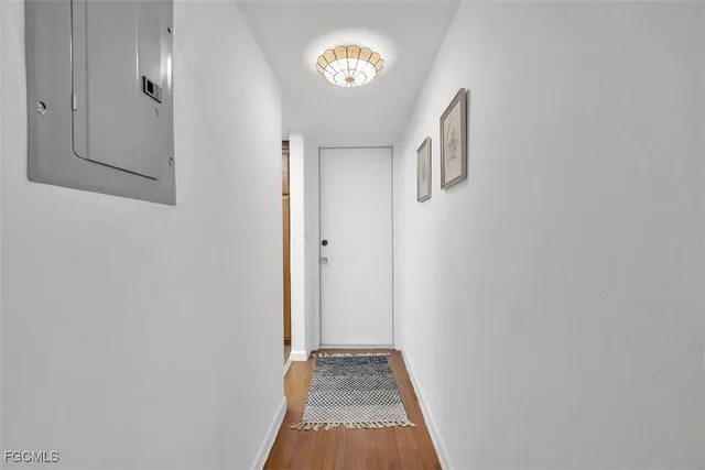 a view of a hallway with wooden floor