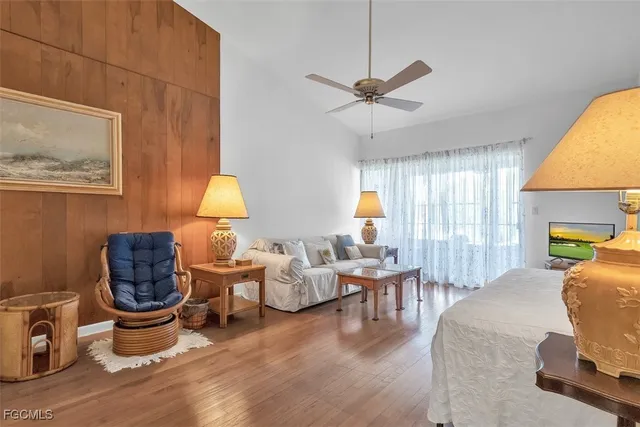 a living room with furniture a window and a lamp