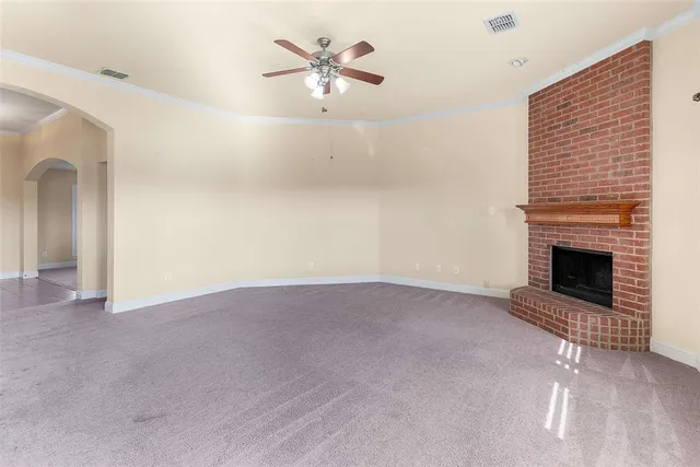 a view of an empty room with a fireplace
