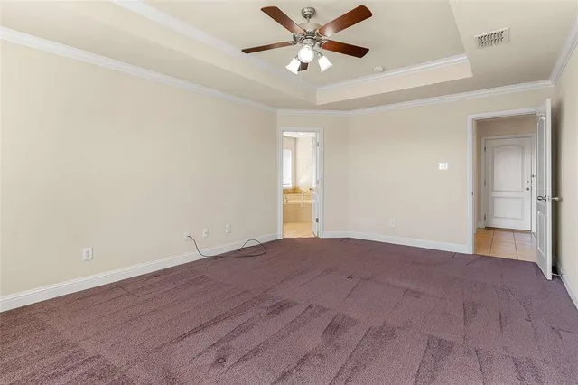 a view of empty room with window and ceiling fan