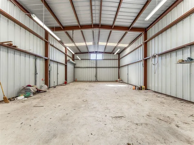 a view of empty room with wooden walls