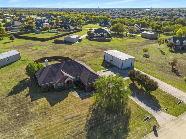 an aerial view of residential houses with outdoor space