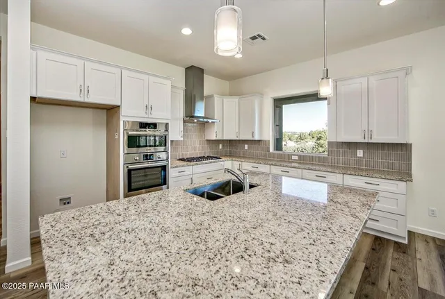 a white bath tub sitting next to a white sink