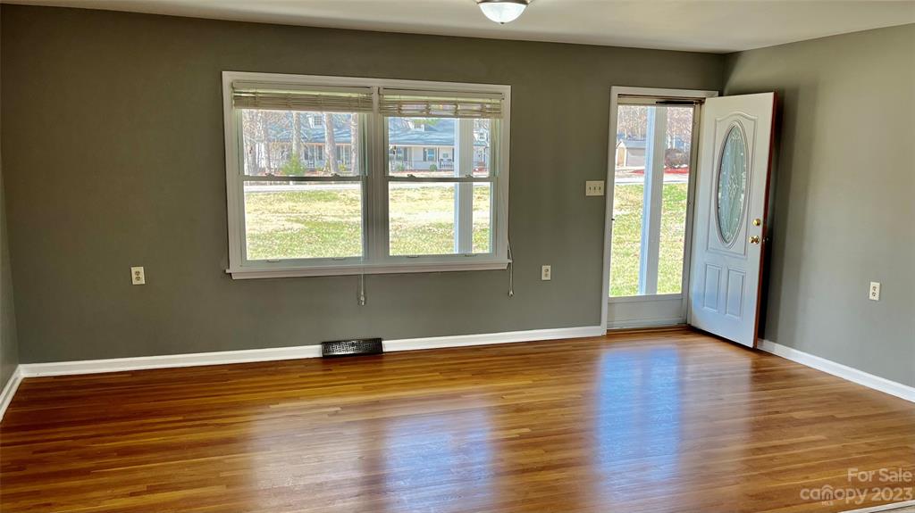 6440 Miller Road Kannapolis, NC 28081 - Photo 13 of 15 a view of an empty room with wooden floor and a window
