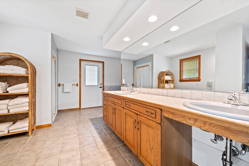 121 Setterland Farm Road Hanover, MA 02339 - Photo 14 of 33 a spacious bathroom with a double vanity sink and a mirror
