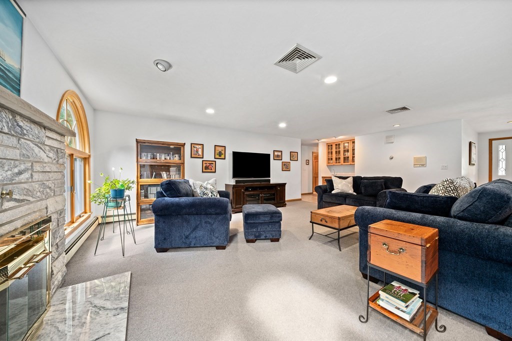 121 Setterland Farm Road Hanover, MA 02339 - Photo 10 of 33 a living room with furniture and a flat screen tv